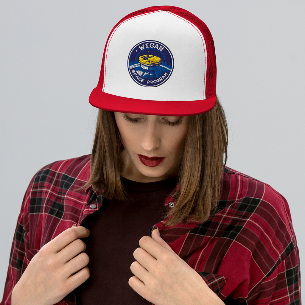 Person wearing a white and red cap with a logo, against a plain background