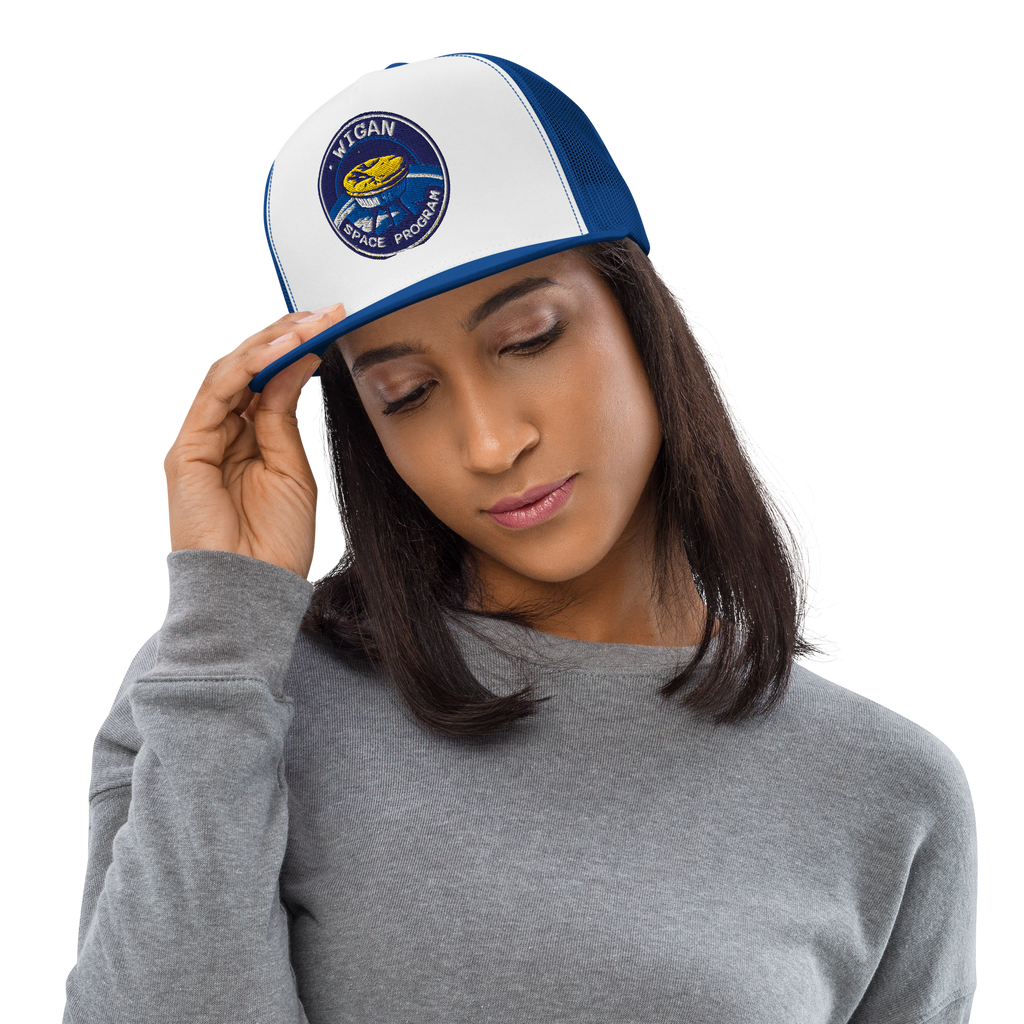 Woman wearing a white and blue cap with a logo, on a plain background