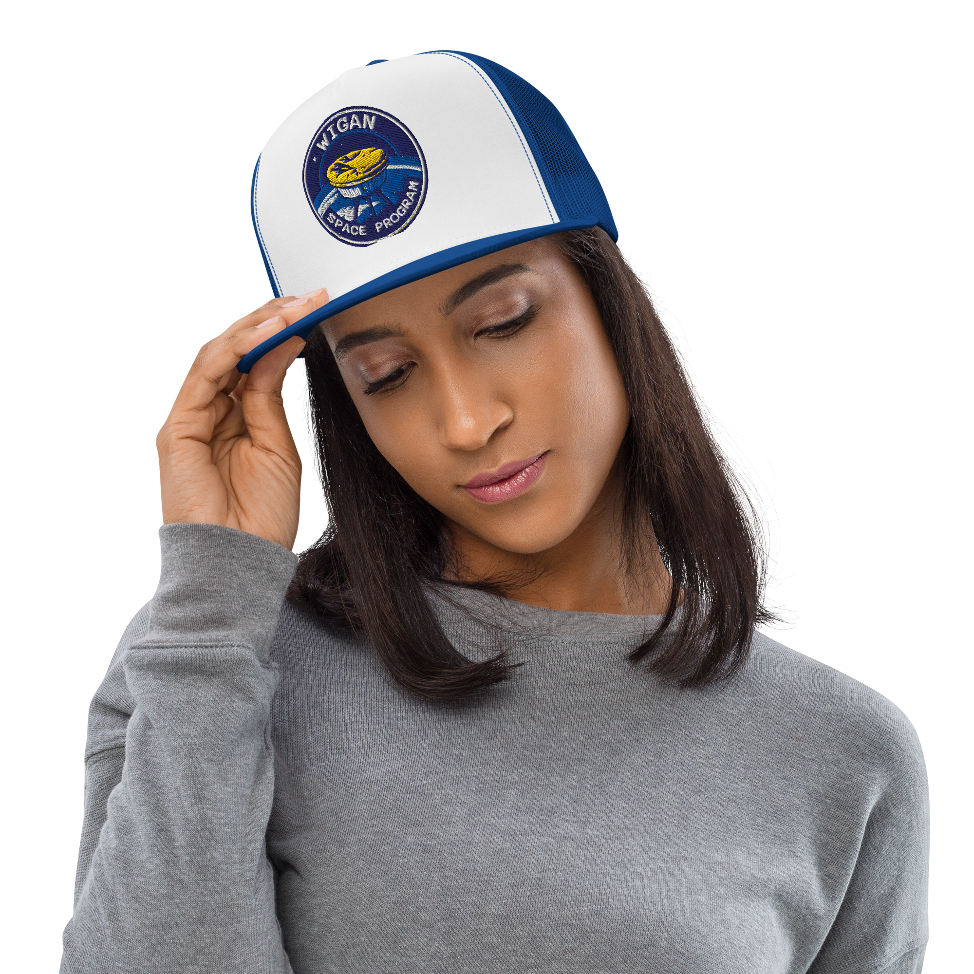 Woman wearing a white and blue cap with a logo, on a plain background