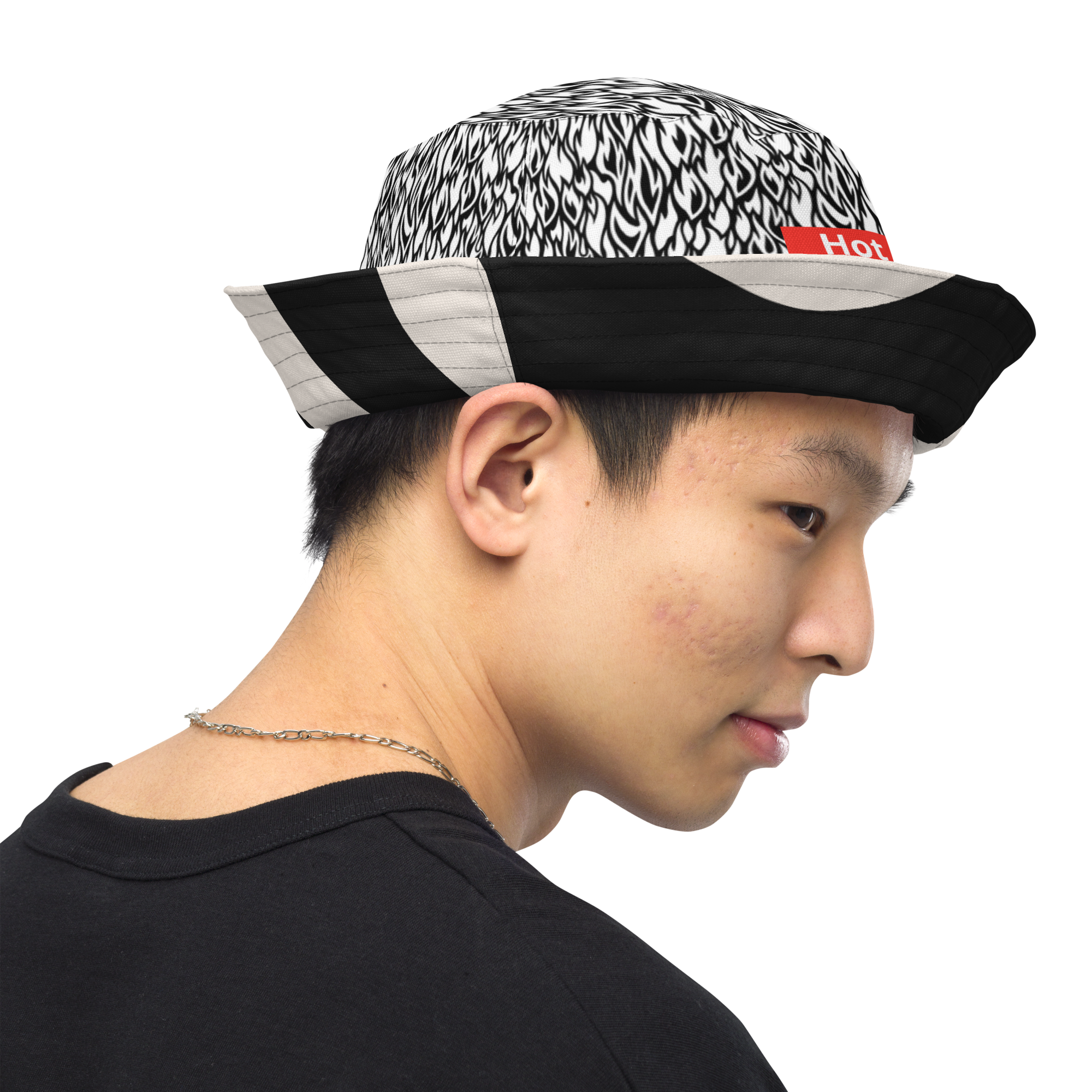Person wearing a black and white patterned cap with a red logo on a white background
