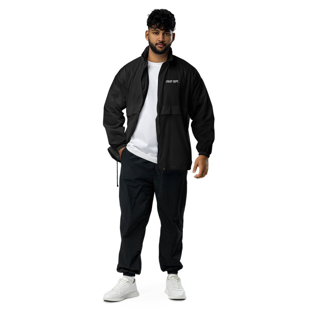 Man wearing a black tracksuit with a white shirt on a white background
