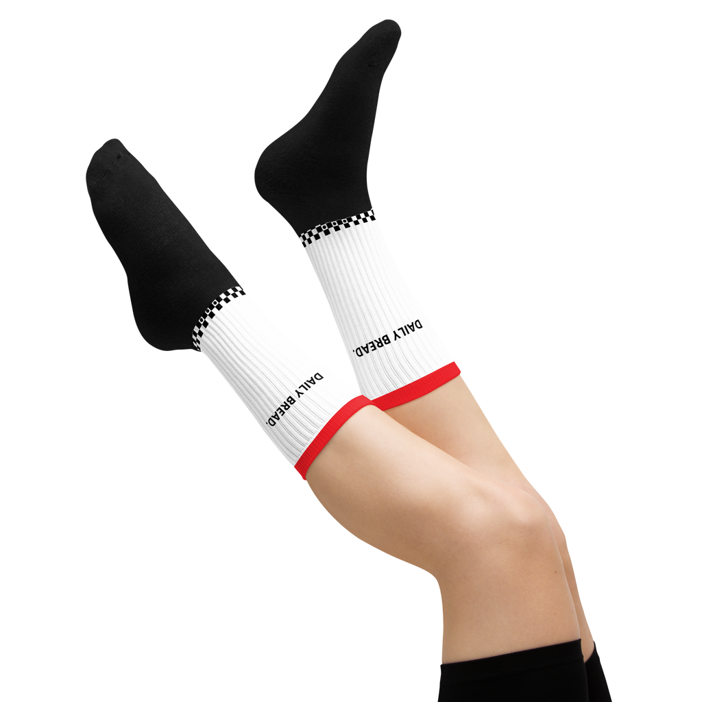 White socks with black text and red accents worn by a person on a white background