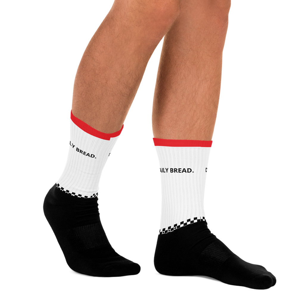 White socks with red accents and black text worn by a person on a white background