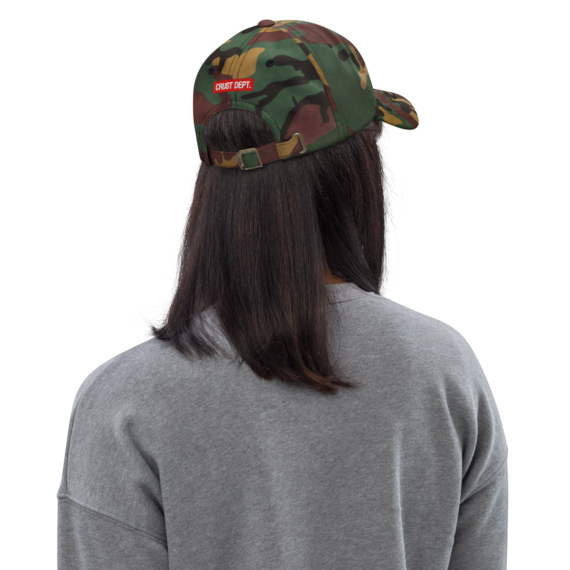 Person wearing a camouflage cap with 'CRUST DEPT.' logo on a white background