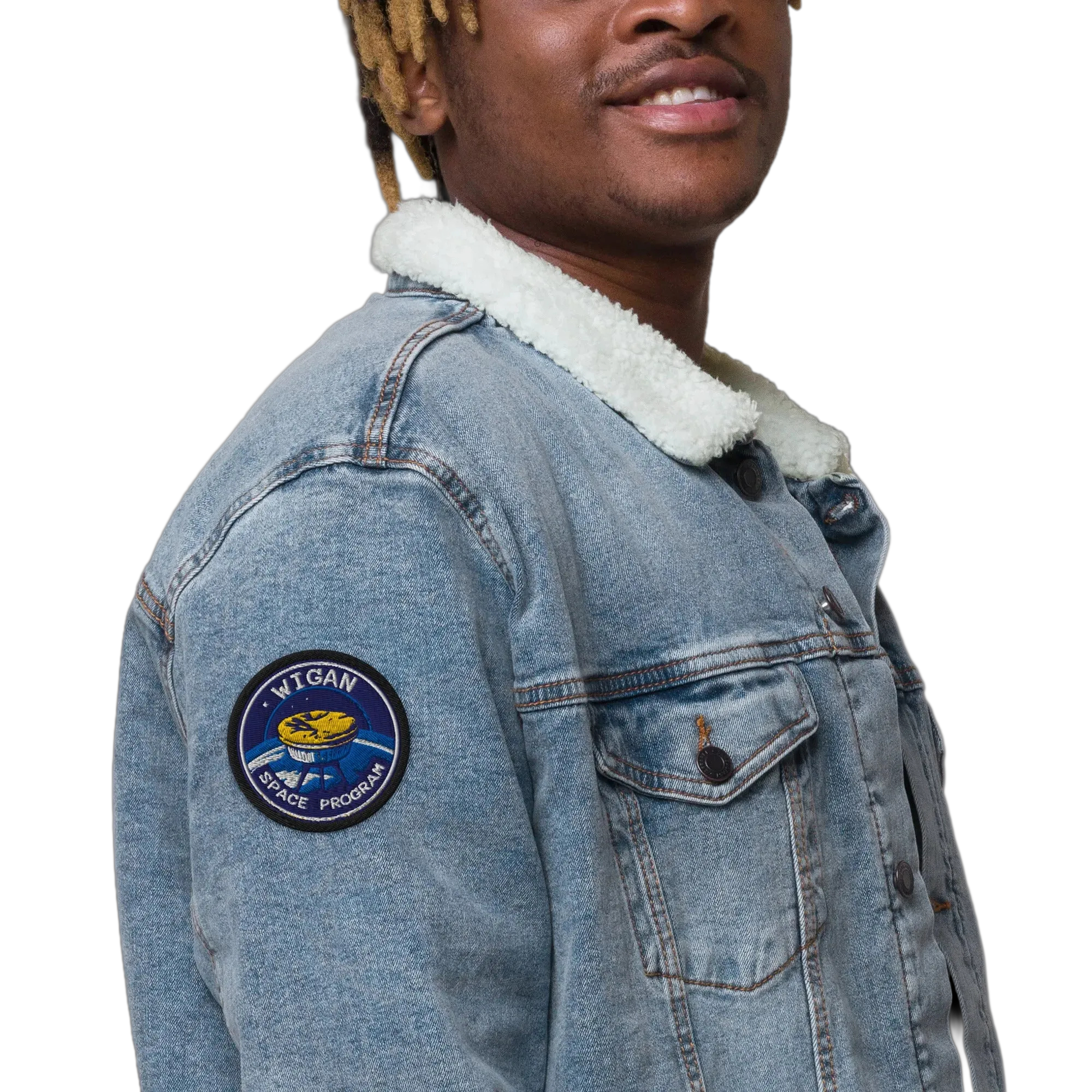 Person wearing a denim jacket with a patch on a white background