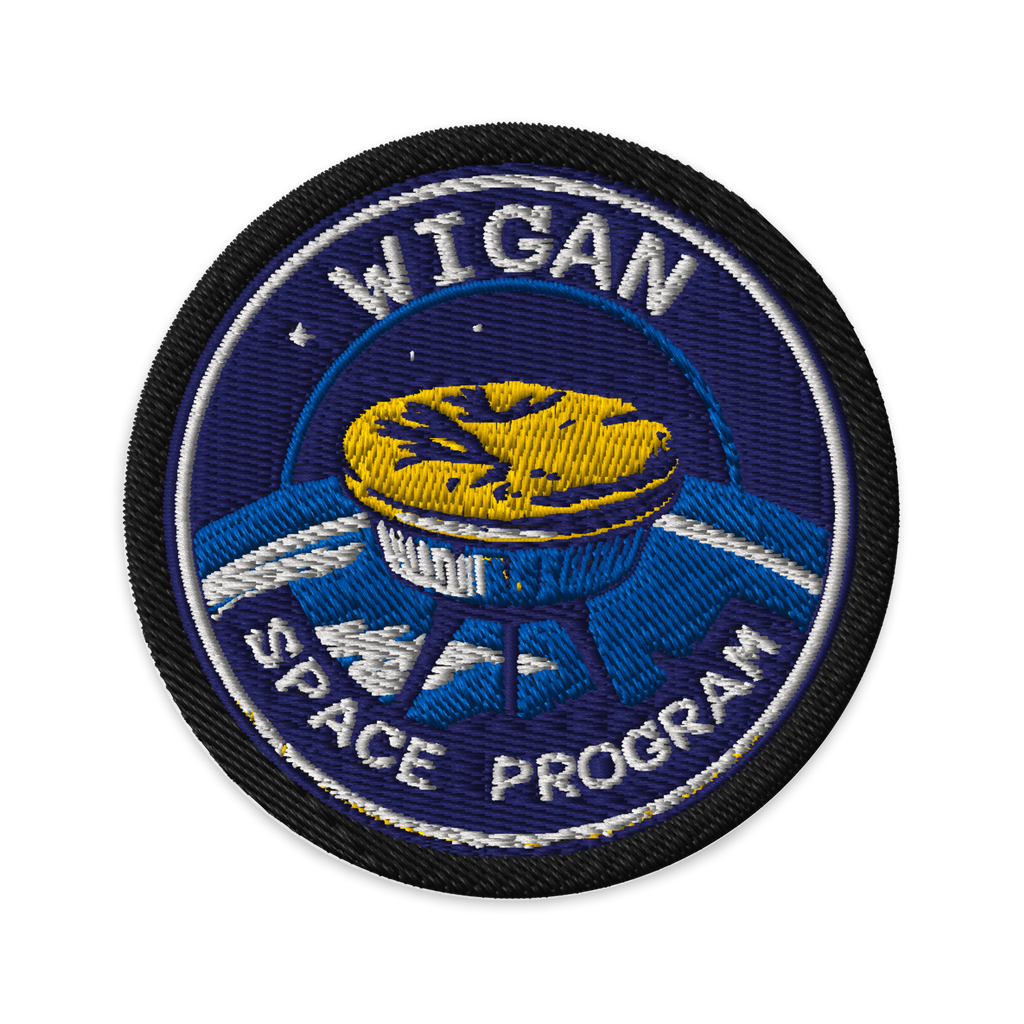 Circular patch with 'Wigan Space Program' text and space-themed design on a white background