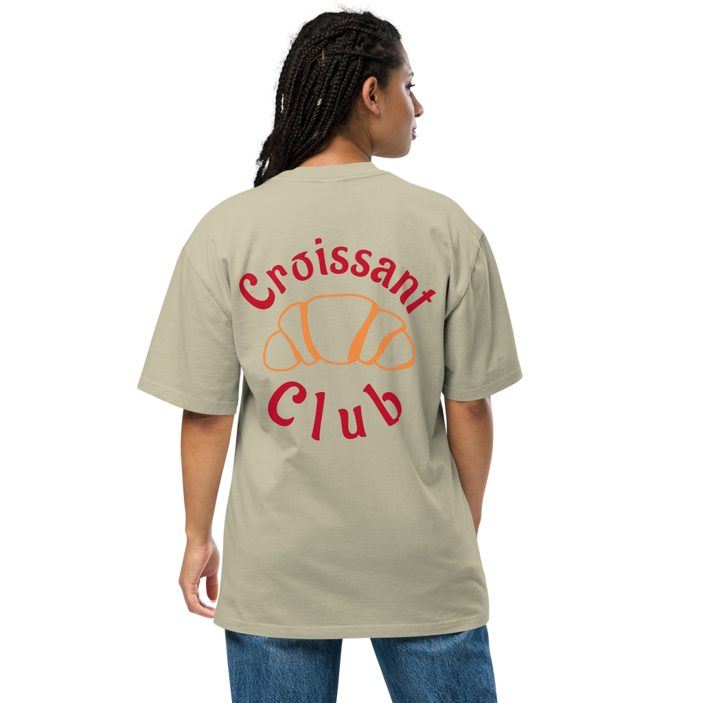 Person wearing a eucalyptus t-shirt with 'Croissant Club' text and logo on the back.