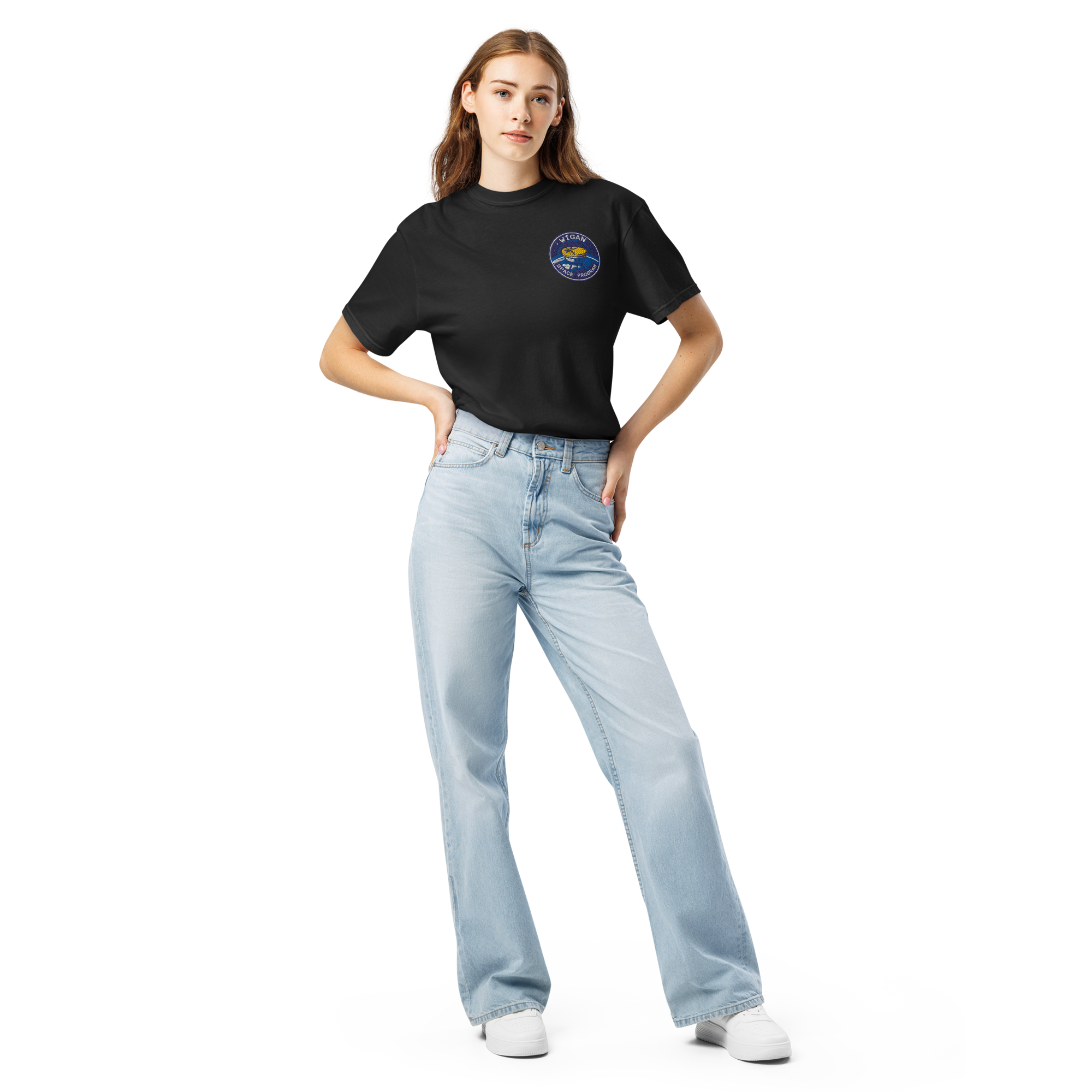 Woman wearing a black t-shirt with a logo and light blue jeans on a white background