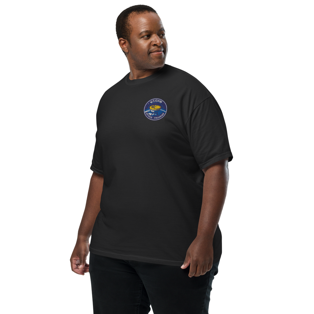 Man wearing a black t-shirt with a logo on a white background