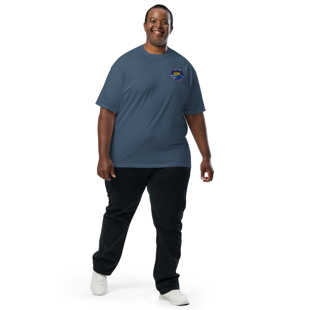 Man wearing a blue t-shirt with a logo on a white background