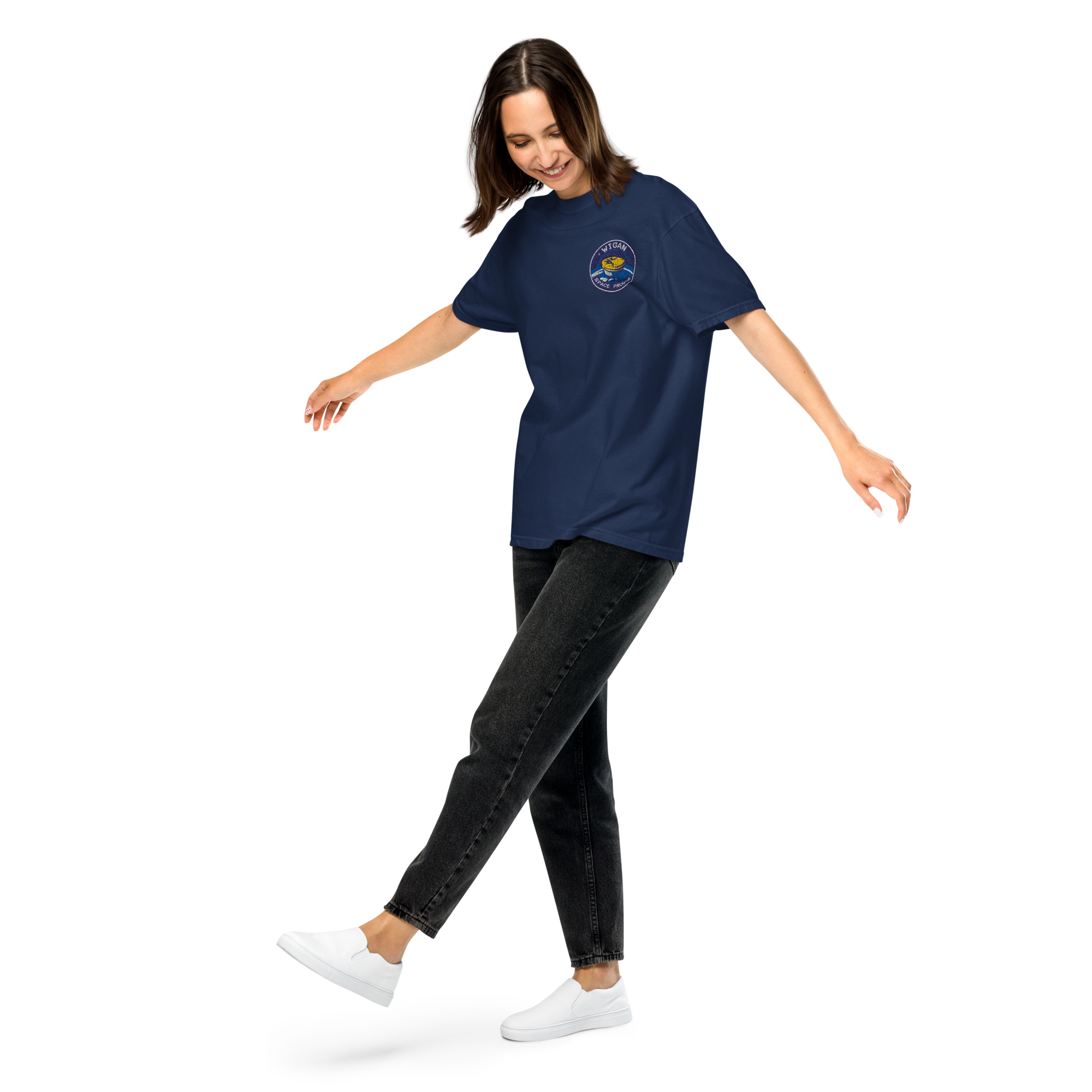 Woman wearing a navy blue t-shirt with a logo, black jeans, and white sneakers on a white background